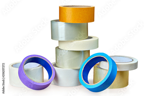 Different rolls of duct tape lie on table,  white background. photo