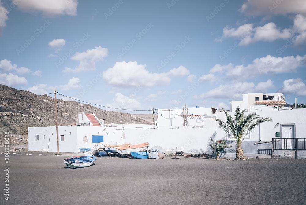 white buildings and small boats on beach against blue sky on Fuerteventura, Canary Islands, Spain