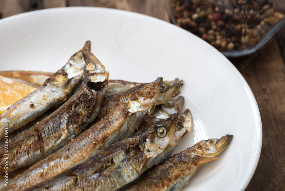 Grilled fish capelin or shishamo on white plate
Grilled fish capelin or shishamo on white plate