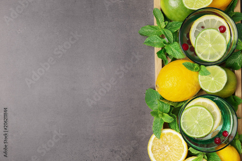 Flat lay composition with detox lemonade and ingredients on grey background