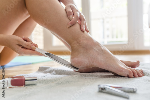 Woman having pedicure to her legs. Treatment of feet and nails.