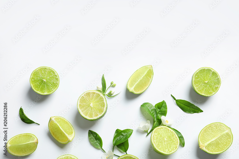 Composition with fresh ripe limes on white background, top view