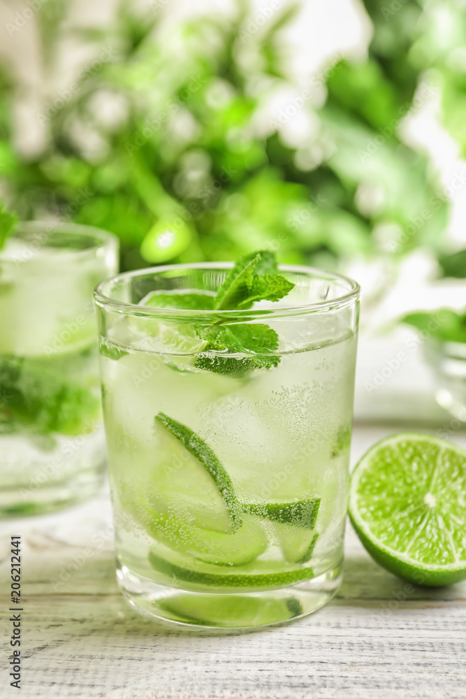 Refreshing beverage with mint and lime on table Refreshing beverage with mint and lime on table