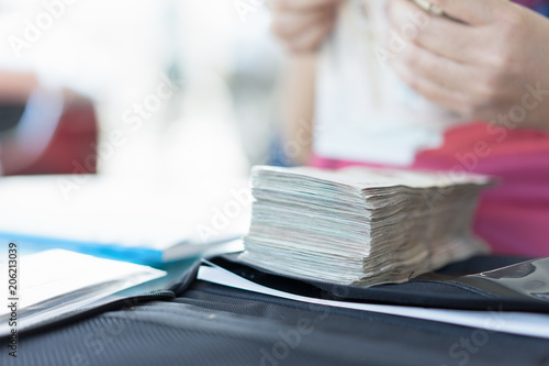 Asian woman girl hand counting cash money for pay loan.