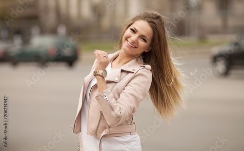 Young smiling woman outdoors portrait. Soft sunny colors.Close portrait.