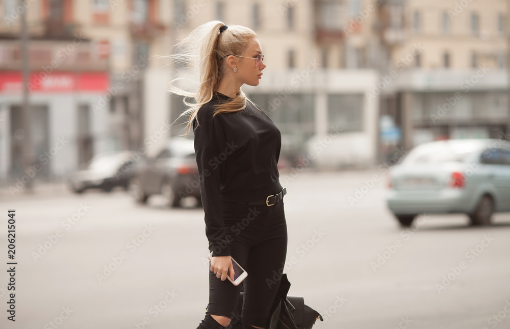Portrait of young beautiful blond woman outdoor in the city