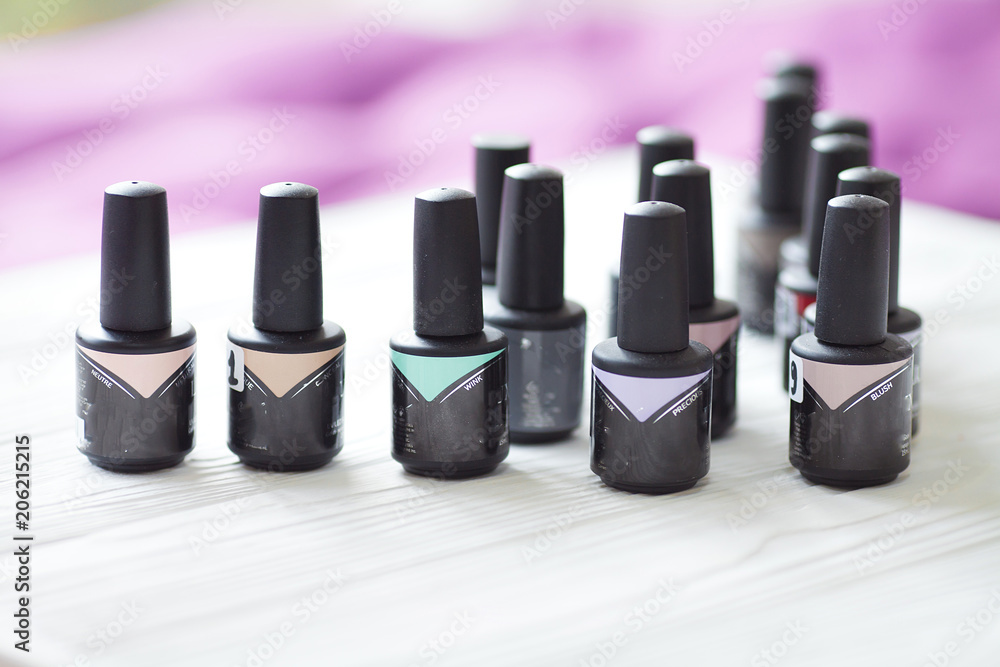 Group of nail polishes of different colors on blurred background Group of nail polishes of different colors on blurred background