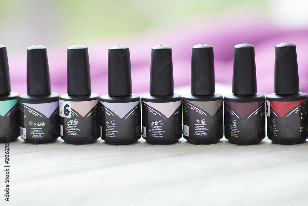 Group of nail polishes of different colors on blurred background Group of nail polishes of different colors on blurred background