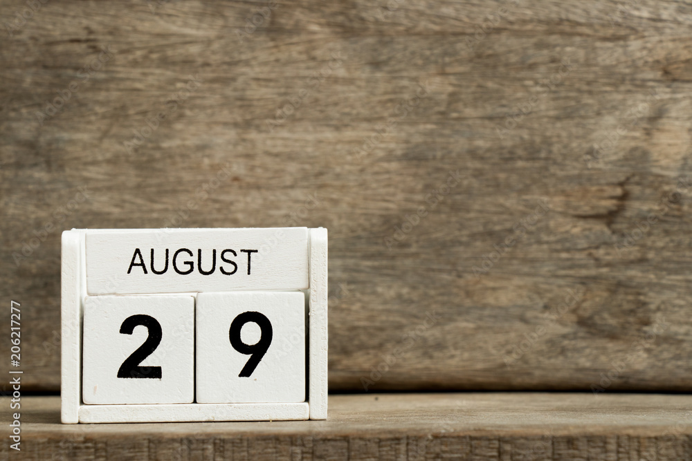 White block calendar present date 29 and month August on wood background White block calendar present date 29 and month August on wood background