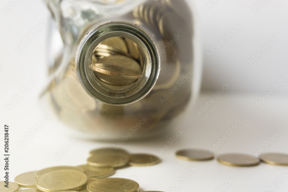 Golden coin in glass bottle, Saving money concept.