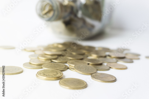 Golden coin in glass bottle, Saving money concept.