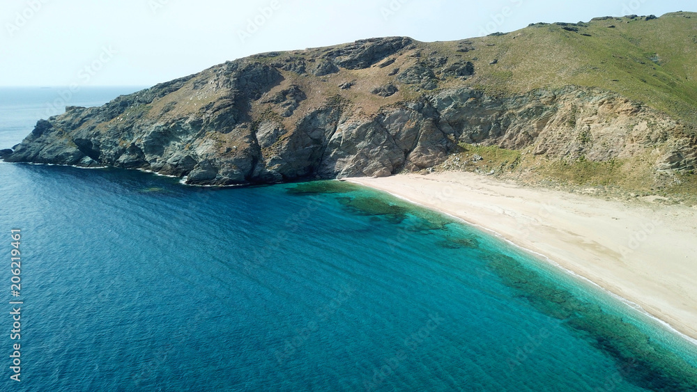Aerial drone bird's eye view photo of iconic beach with turquoise clear waters located in Greek island