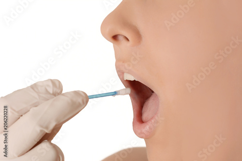 Doctor holding using a swab to check patient s throat