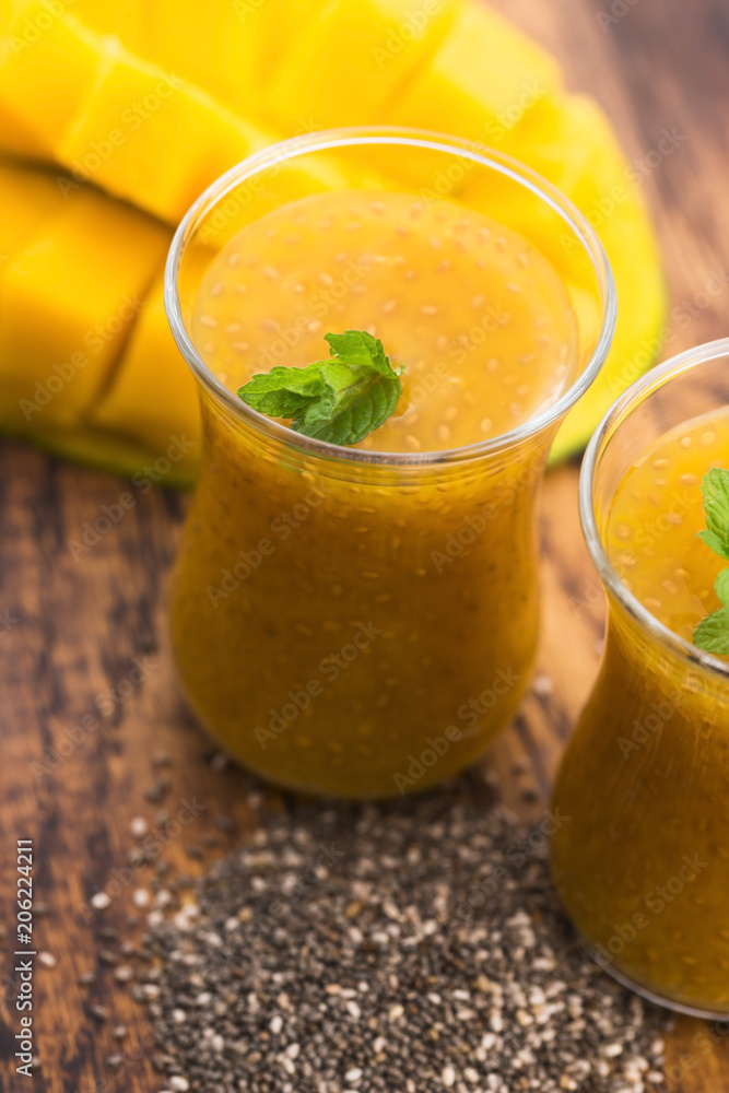 Fresh mango smoothie in glass with chia seeds Fresh mango smoothie in glass with chia seeds