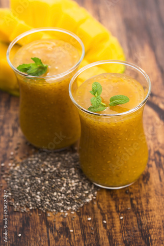 Fresh mango smoothie in glass with chia seeds