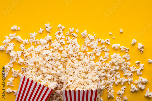 Buckets of popcorn on yellow background, top view © Prostock-studio