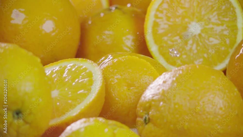 Orange falling in juice with splash between oranges. Slow motion Orange falling in juice with splash between oranges. Slow motion