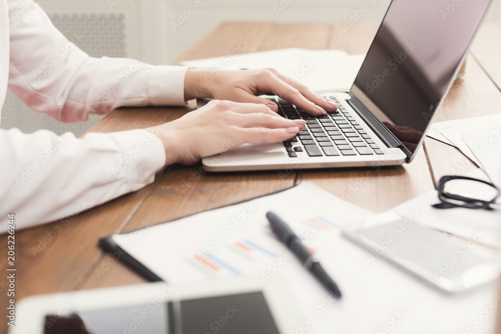 Woman hands on keyboard at working table Woman hands on keyboard at working table