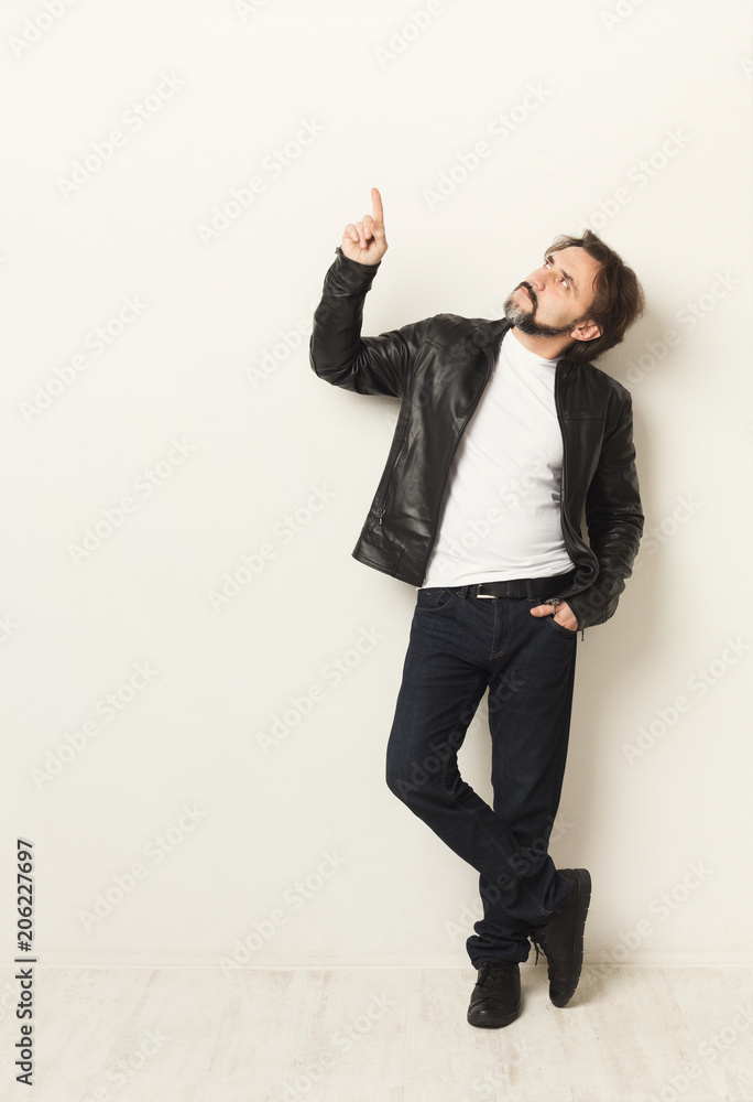 Confident man point up over white background, copy space Confident man point up over white background, copy space