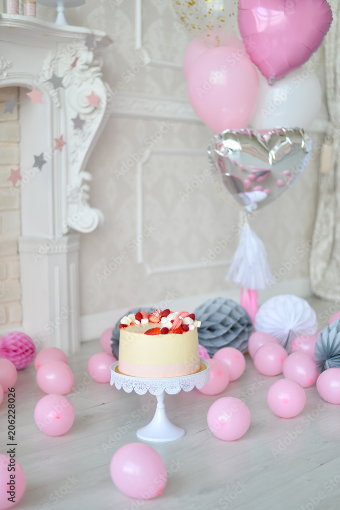 One year birthday Cake. Cake for holiday party. a lot of balloons pink and grey colors. 