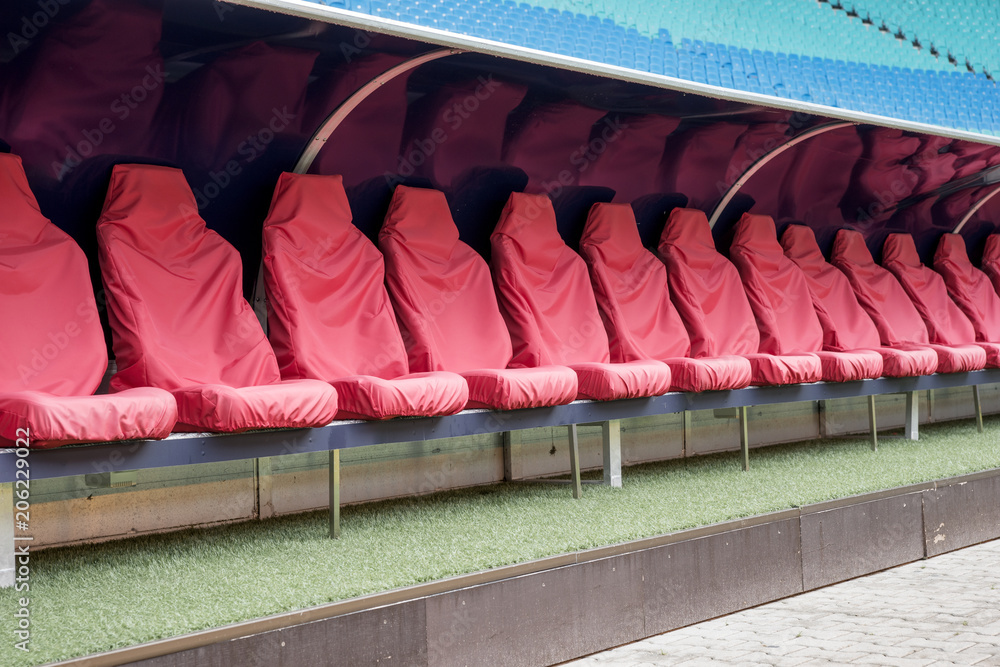 Obraz premium Detail of red Reserve chair and staff coach bench in sport stadium