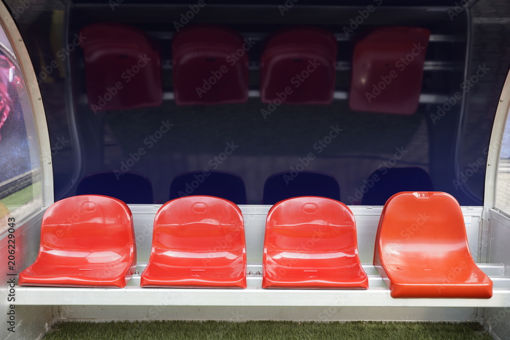 Fototapeta premium Detail of red Reserve chair and staff coach bench in sport stadium