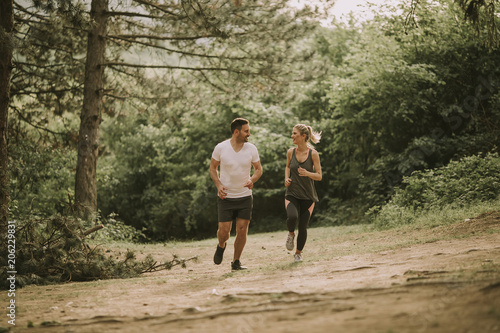 Couple jogging outdoors in ...
