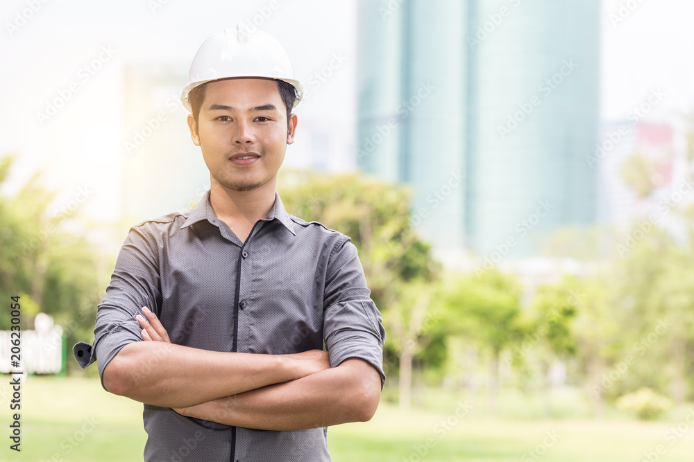 Engineer with safety white helmet cross arm and smile feeling so happiness and confident with copy space Engineer with safety white helmet cross arm and smile feeling so happiness and confident with copy space