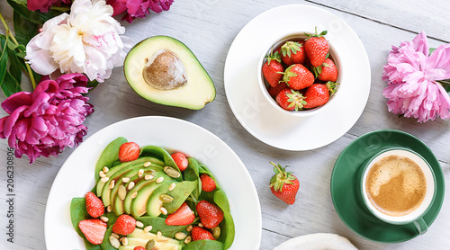 breakfast vegan salad with avocado, strawberries, pine nuts