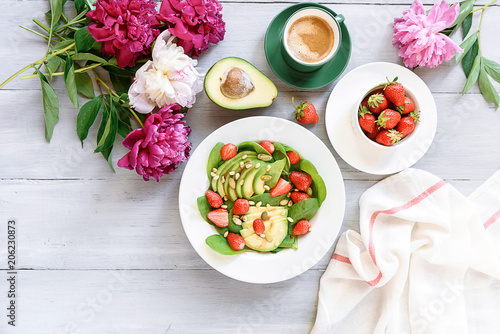 breakfast vegan salad with avocado, strawberries, pine nuts