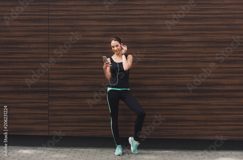 Woman choose music to listen during workout