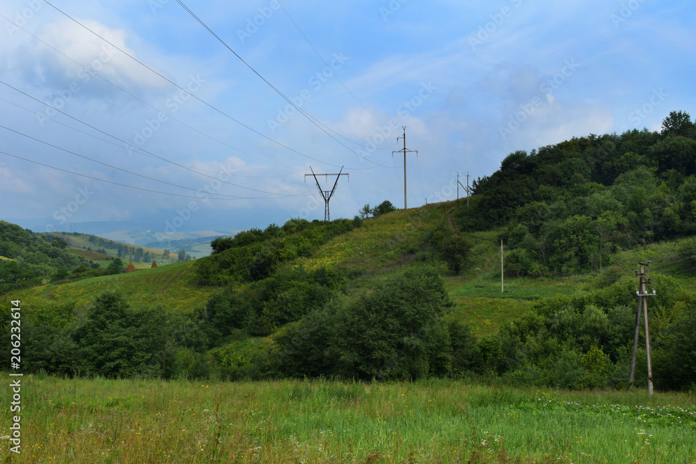 Transmission power line. A row of electricity pylons stretch across Carpathian mountains, in the Ukraine. Transmission power line. A row of electricity pylons stretch across Carpathian mountains, in the Ukraine.