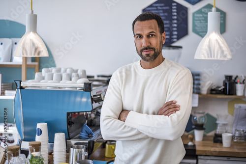 Portrait of confident owner of a cafe photo