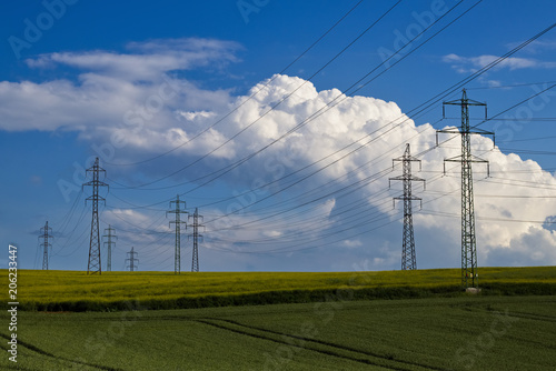 Electric transmission tower in field, electricity concept