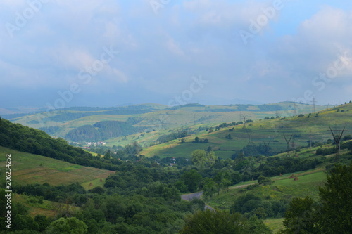 Transmission power line. A row of electricity pylons stretch across Carpathian mountains, in the Ukraine. © Oksana_S