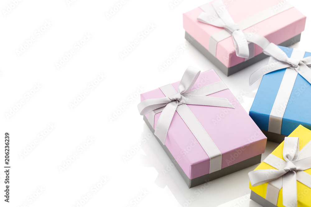 Small colorful gift boxes with ribbon bows on white background Small colorful gift boxes with ribbon bows on white background