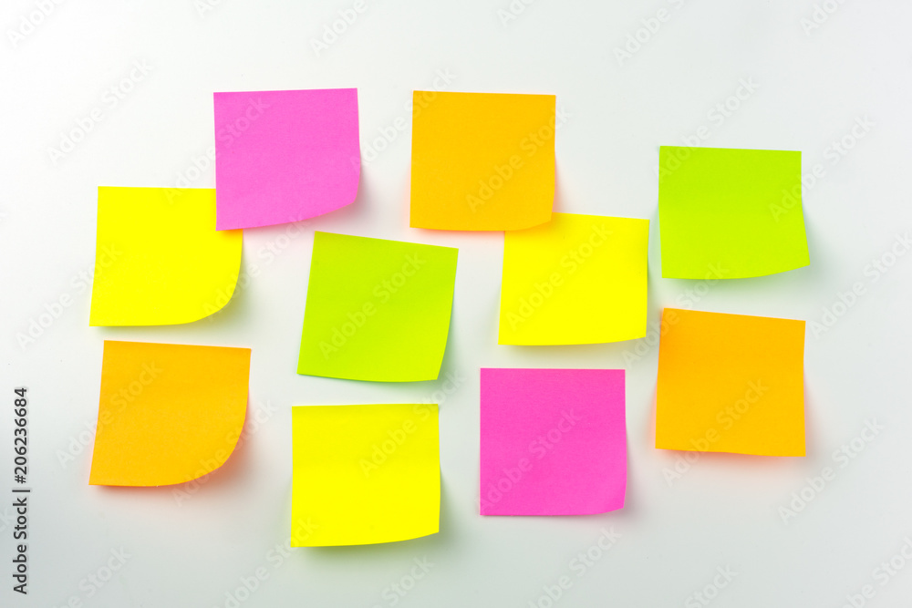 Collection of different colored sheets of note papers the stick on the wall, ready for your message. Collection of different colored sheets of note papers the stick on the wall, ready for your message.