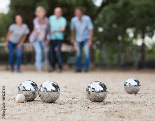 Males and females playing petanque