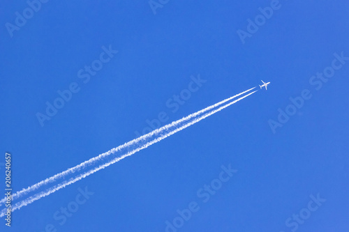 white vapor trail from the jet plane on blue sky