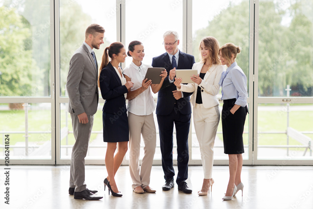 people, technology, work and corporate concept - business team with tablet pc computers at office