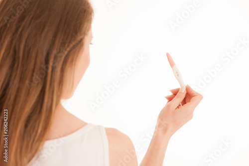 Happy woman with pregnancy test isolated over white background
