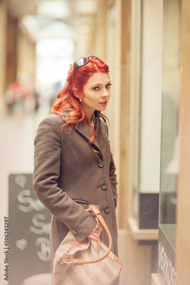 Fototapeta premium Beautiful young woman shopping in the city, mall with shopping bag, happy shopping tour