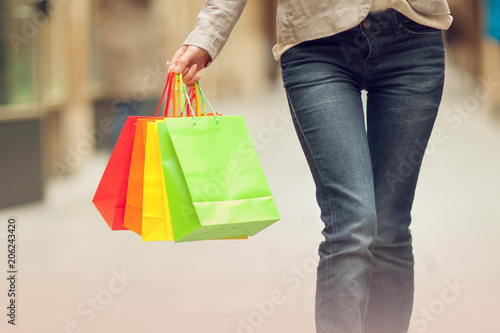 Beautiful young woman shopping in the city, mall with shopping bag, happy shopping tour 