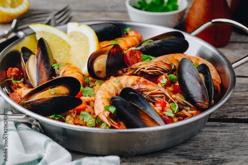 Spanish seafood paella with mussels, shrimps and chorizo sausages in traditional pan