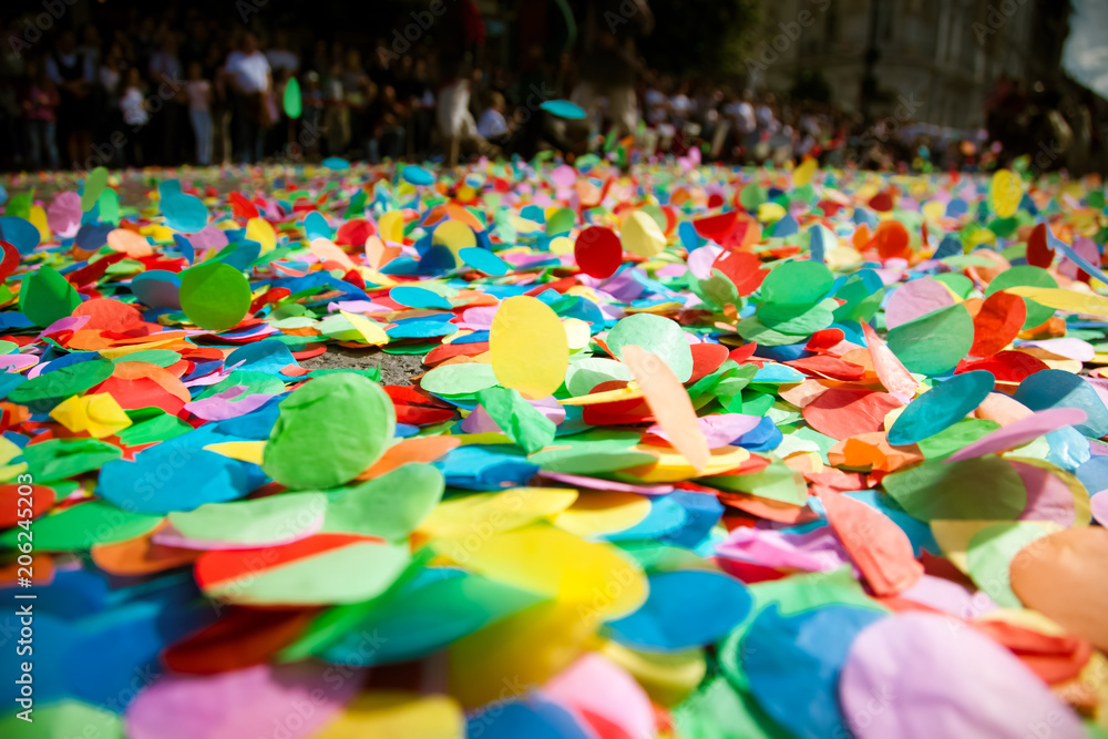 confetti on the ground during a festival or carnival in the city