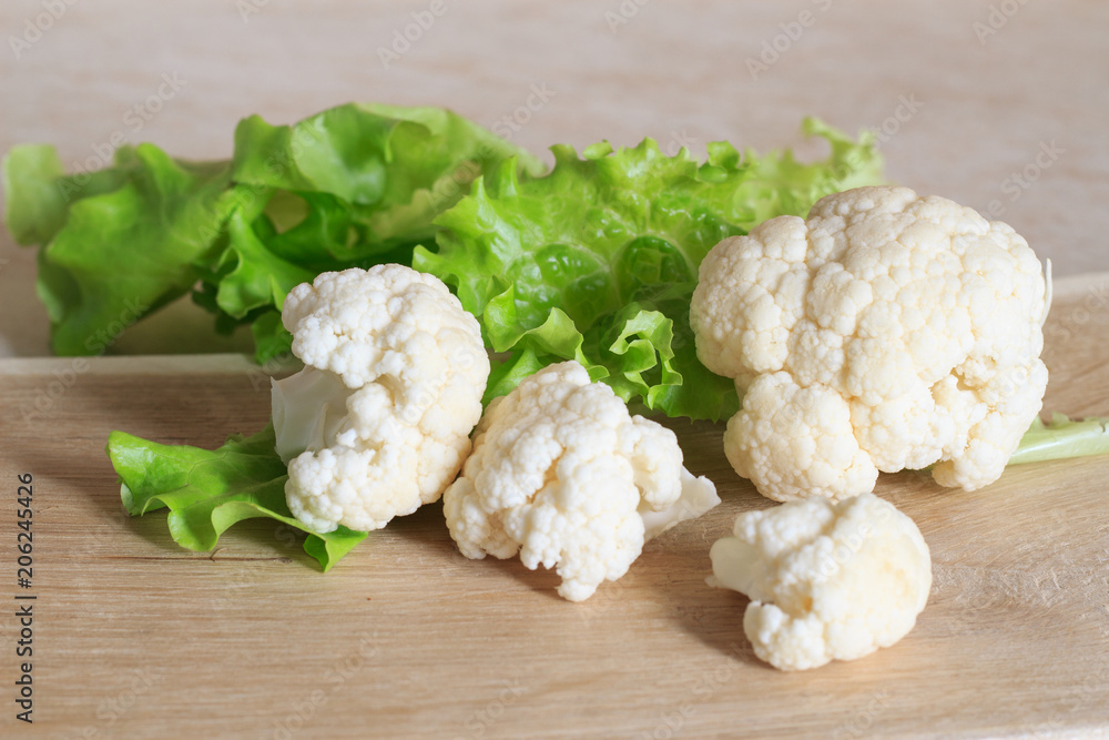 Cauliflower on a wooden background. Close-up. Copy space. Cauliflower on a wooden background. Close-up. Copy space.