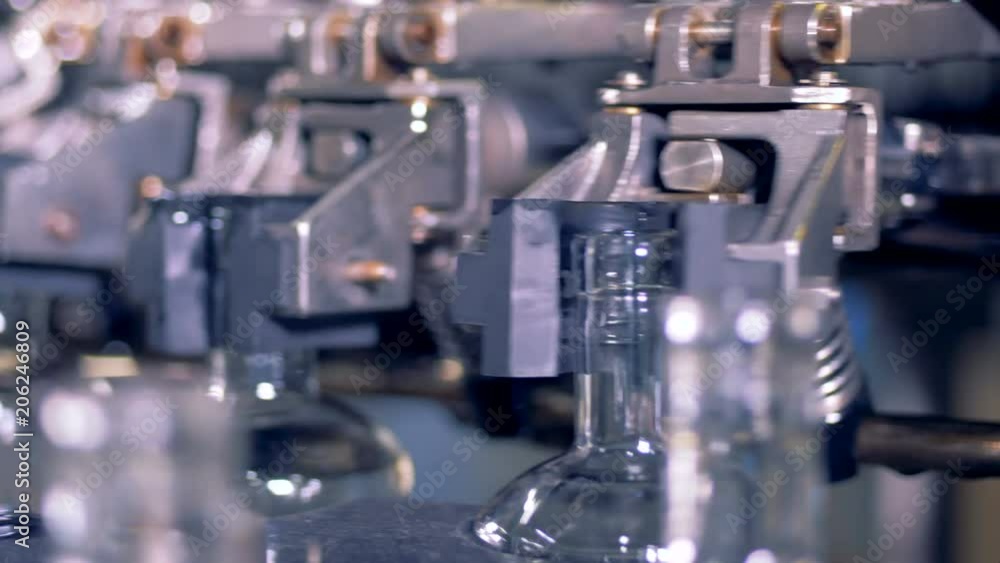 Bottles go on a conveyor, close up. Bottles go on a conveyor, close up.