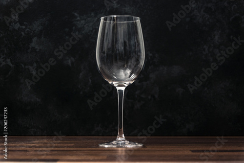 wine glass on the wooden table with dark background