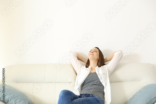 Woman relaxing on a couch with copy space above