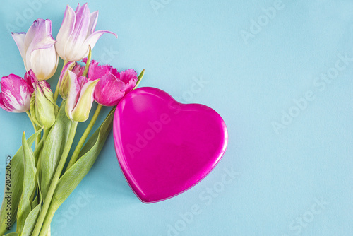 Romantic greeting card/ gift box shape heart and bouquet of tulips on blue background with copy space